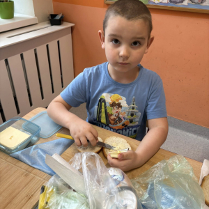 Dziecko przygotowuje zdrową kanapkę.