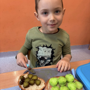 Dziecko przygotowuje zdrową kanapkę.