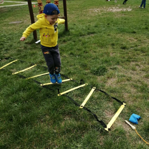 Przedszkolaki uczestniczą w zabawach sportowych.